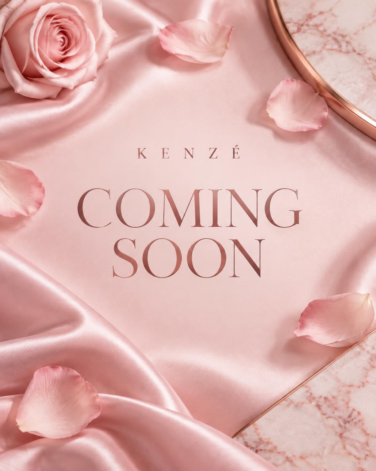 Kenzé Cosmetics — coming soon, styled on blush-pink silk with rose petals
